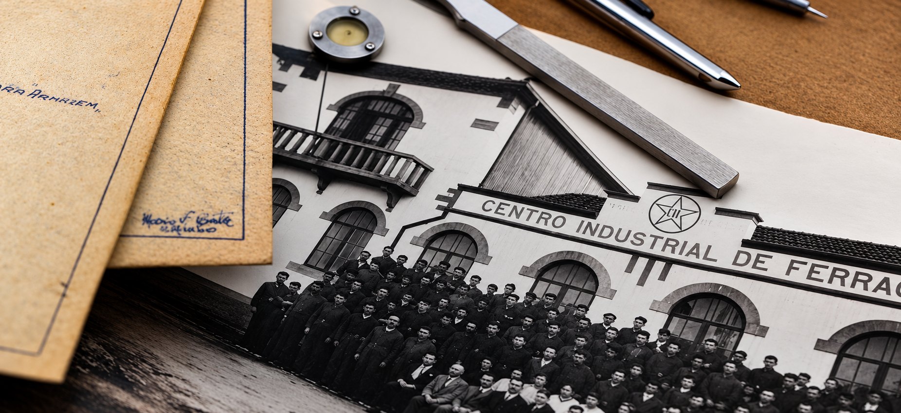 An archive photograph of the Centro Industrial de Ferragens works and its staff, laid out with drawing instruments